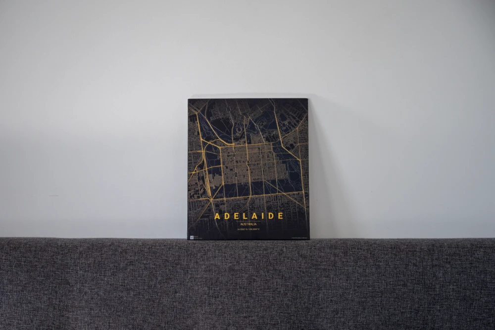 Adelaide wood-board map in gold on dark